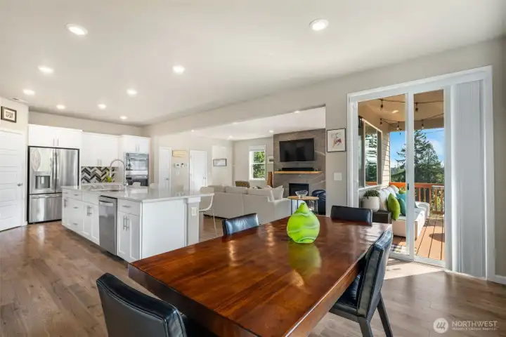 Spacious dining area with direct access to an over-sized BBQ deck for hosting indoor/outdoor gatherings.