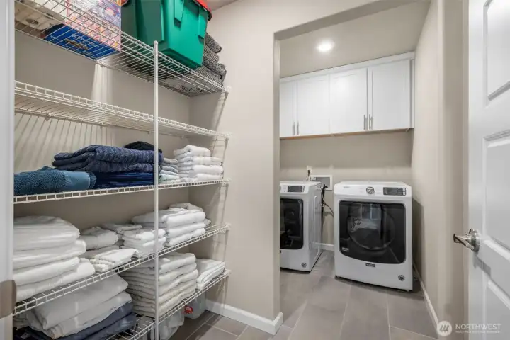 Spacious laundry room with extra storage space for linens