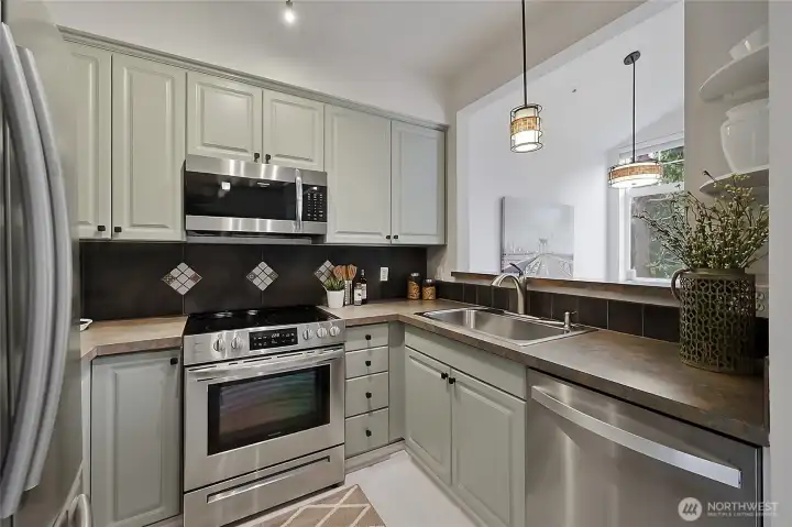 The kitchen boasts stainless steel appliances and abundant cabinet space.