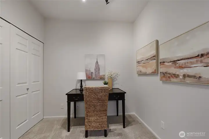 Versatile flex space next to the in-unit laundry provides the perfect spot for a home office.