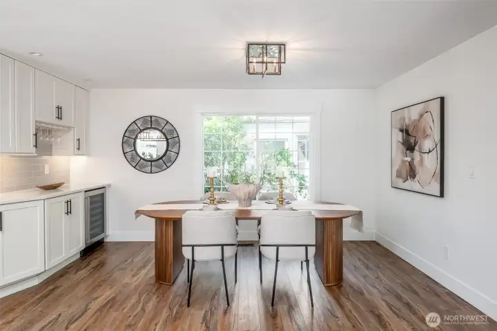 The dining room sits next to a window, and has a perfect coffee or cocktail bar complete with a wine refrigerator.
