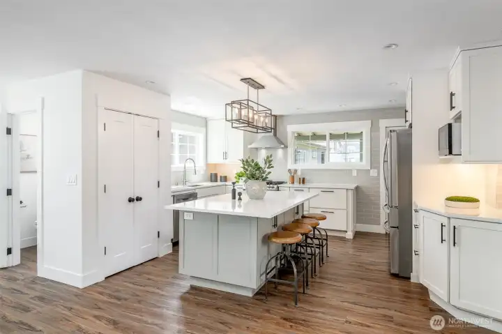 This kitchen is a chef's dream! Plenty of counter space and storage, beautiful appliances, and a large island for serving food.