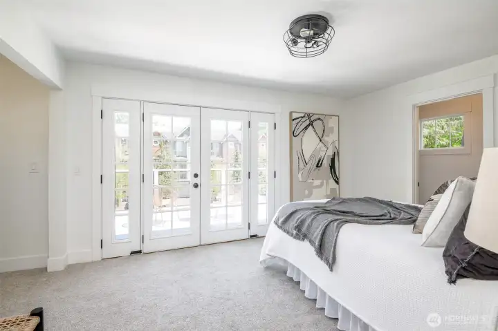 French doors lead out to the deck from this primary bedroom.