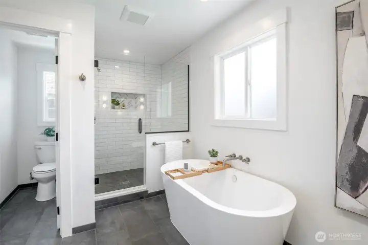 This updated bathroom with a tiled extra large shower and soaking tub is a dream.