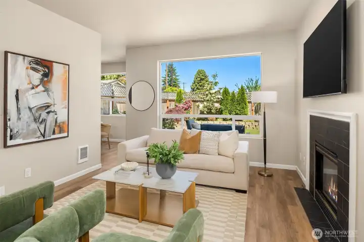 Brand-new flooring and walls of windows create a bright, inviting living space filled with natural light.