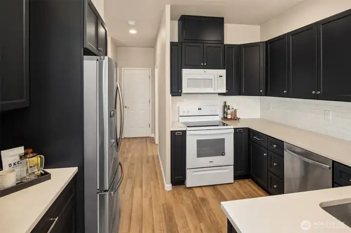 This kitchen is a dream, featuring brand-new cabinetry, quartz countertops, and stylish modern finishes throughout.