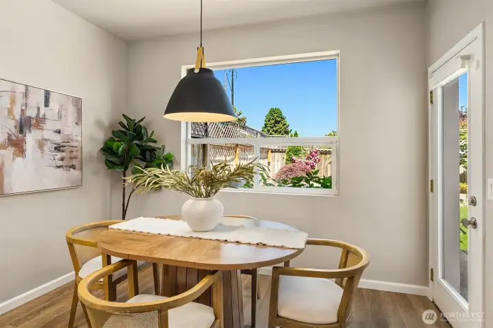 Spacious dining area featuring updated lighting and a welcoming space perfect for everyday meals or entertaining.