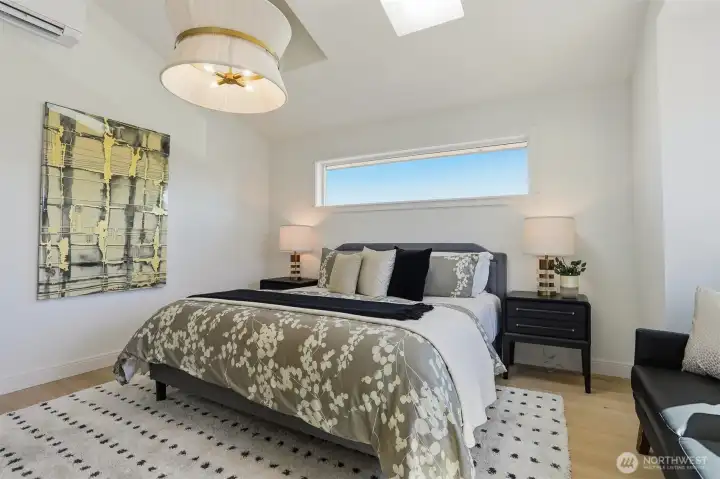 Primary bedroom with vaulted ceilings and skylights. Primary bedroom with vaulted ceilings and skylights.