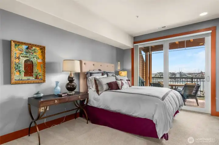 Primary bedroom with a view and slider to the balcony.