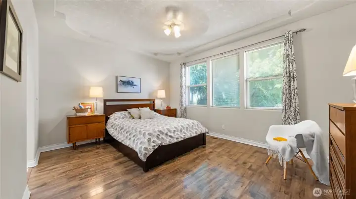Spacious primary suite with views to backyard