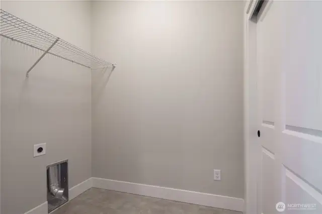 Utility room with linen closet storage.