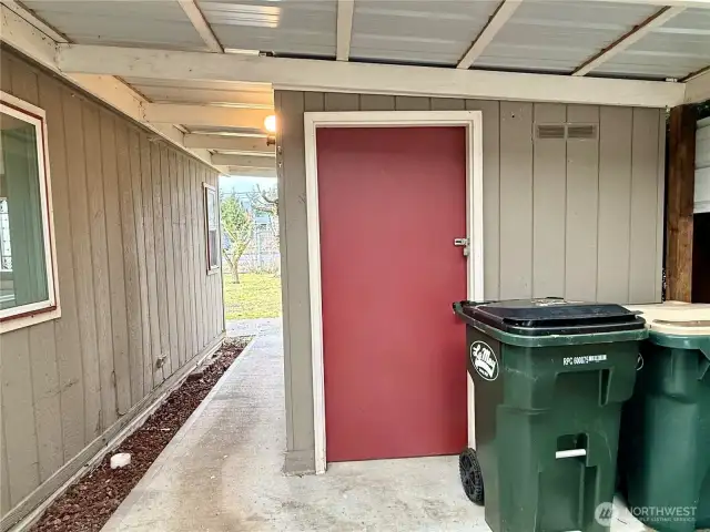 Storage building in back of carport.