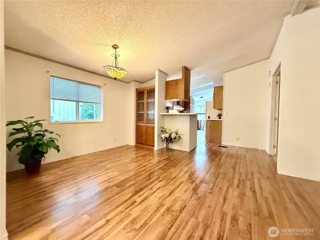 View of the dining area and kitchen and utility/laundry room; also leading to the primary ensuite.