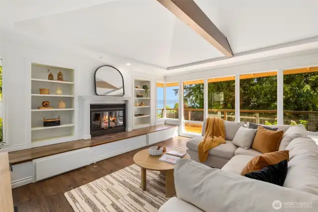 Enjoy soaring ceilings, open beams and custom built-ins surrounding the fireplace in this gorgeous living area.
