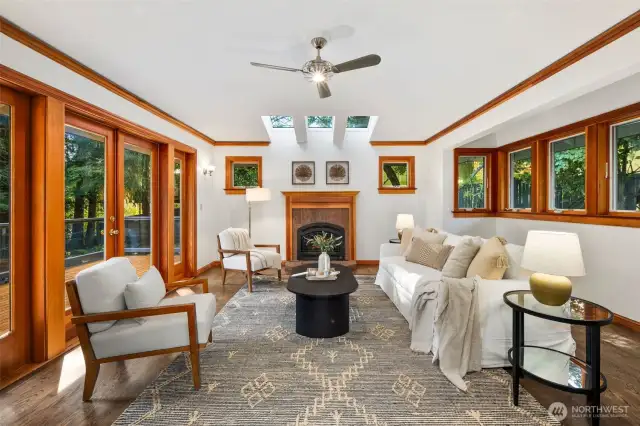 Family room features skylights and an elegant fireplace and open effortlessly onto outdoor deck for al fresco living