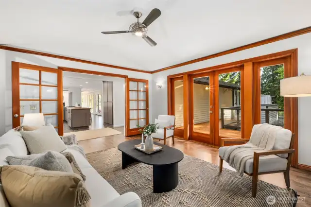 Family room features skylights and an elegant fireplace and open effortlessly onto outdoor deck for al fresco living
