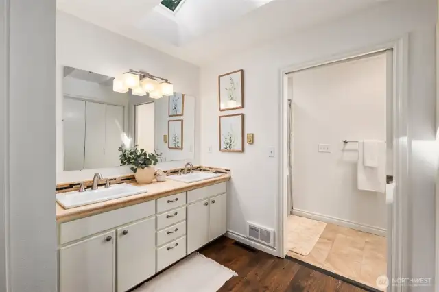 The primary suite bathroom has a walk through closet and 3/4 bath with walk-in shower
