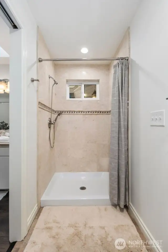 The primary suite bathroom has a walk through closet and 3/4 bath with walk-in shower