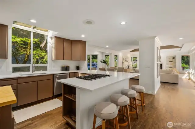 Elegantly refreshed, this chef’s kitchen showcases gleaming quartz countertops, premium stainless steel appliances, and a corner island with seating for up to eight—designed for both lavish entertaining and everyday living.