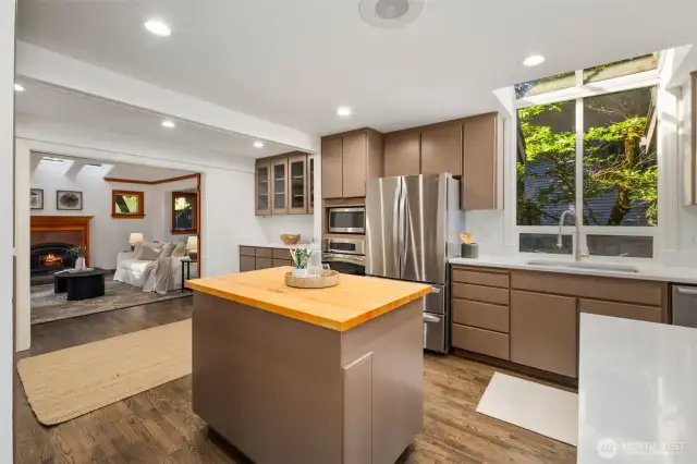 Elegantly refreshed, this chef’s kitchen showcases gleaming quartz countertops, premium stainless steel appliances, and a corner island with seating for up to eight—designed for both lavish entertaining and everyday living.