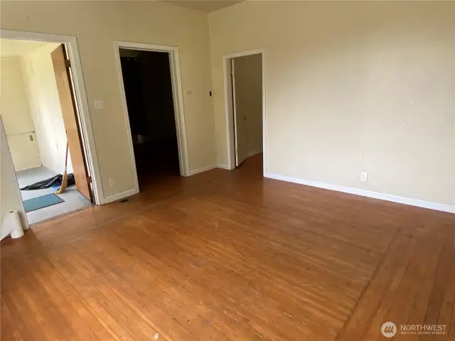Living room leads to both bedrooms, as well as the light filled entry that would be a great reading nook or plant room.