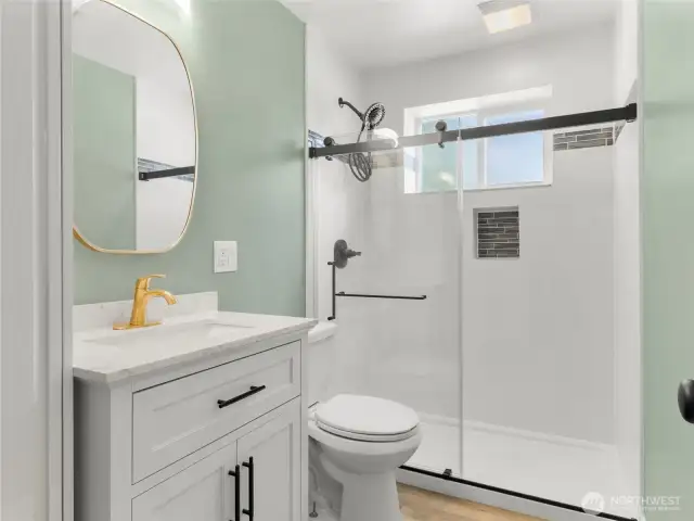 Fresh downstairs bath with step in shower and towel cupboard.