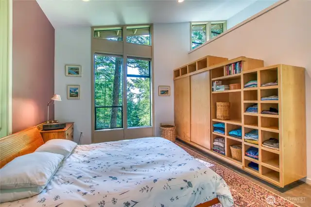 You feel like you are waking up in the woods with the serene view out side the window. Built-in shelving and closet space complete the room.