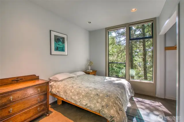 The second bedroom has the same forest view.