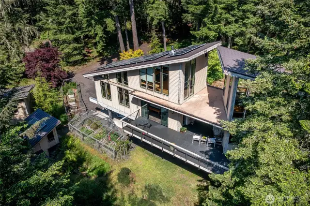 The home has multiple amenities including a detached two car garage, chicken coop, tree house, and other outbuildings.