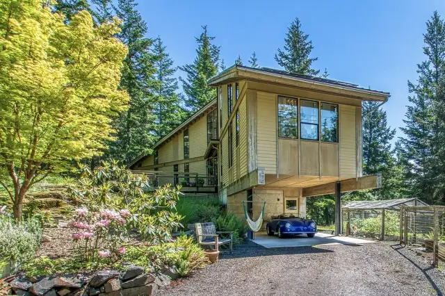 The dramtic cantilevered living room over the protected carport and second entrance into the home