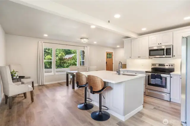 Another look at the kitchen with the breakfast bar looking toward the front door.