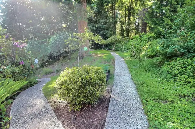 Path from the house up to level garden area and to the right is towards the basement entry