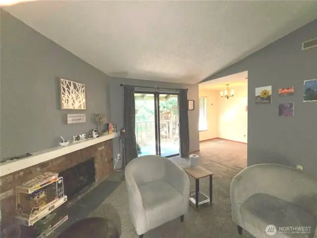 Living room features a comfy wood burning fireplace