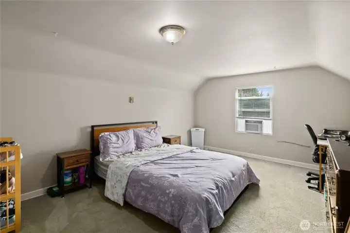 Spacious primary bedroom with fresh paint.