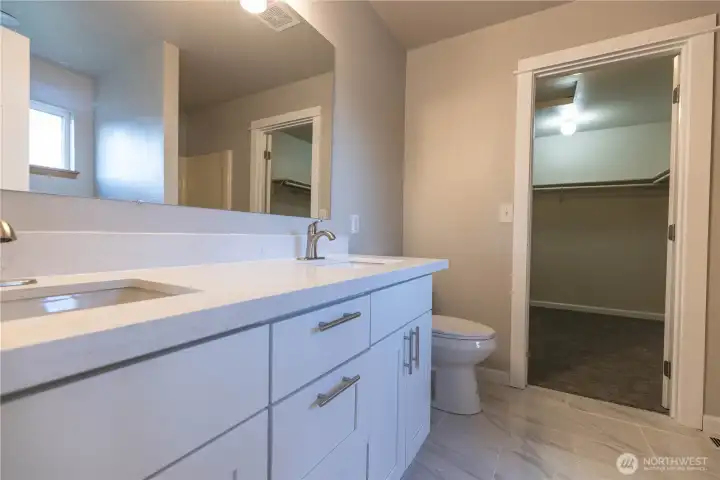 Primary bath looking into the spacious walk in closet