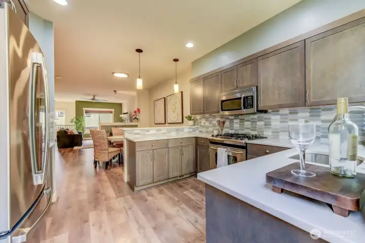 Kitchen eating bar, stainless appliances gas stove, lots of light with door out to deck (updated cabinets, and quartz counters)