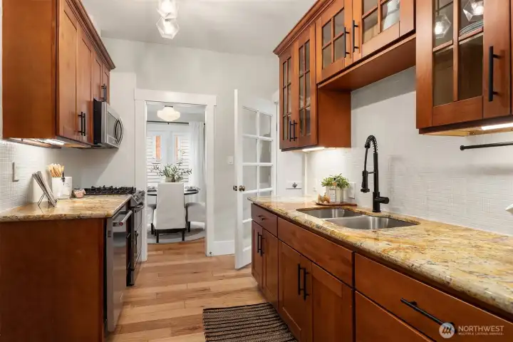 Glass door leads to tiled mud room...