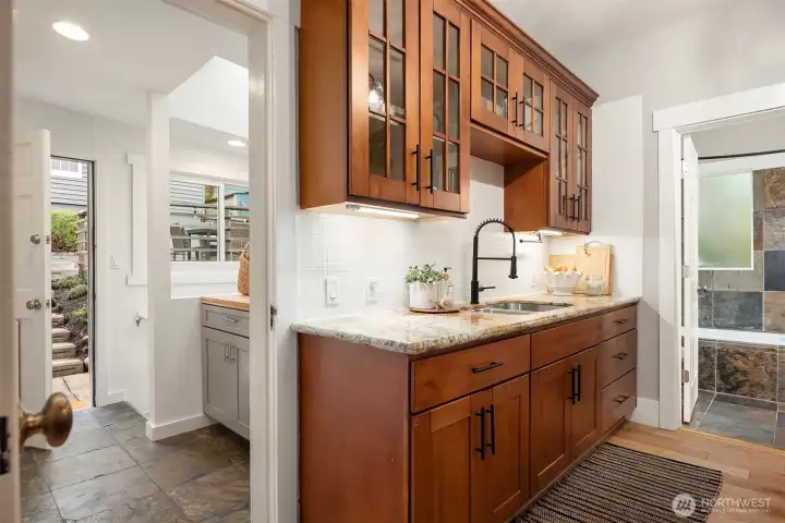 Mud room off kitchen with easy access to back yard, deck and parking; as well as access to finished lower level of home.