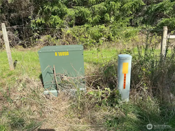 Underground power box and phone on SE corner of property.