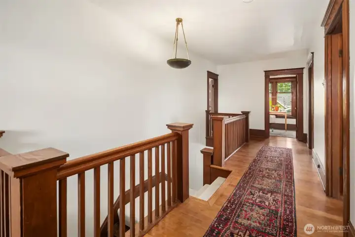 Use either side of the double stairway to come up to The Primary Bedroom with full bath + 3 additional large bedrooms, an office with a great territorial outlook, another charming vintage bath and a convenient laundry.