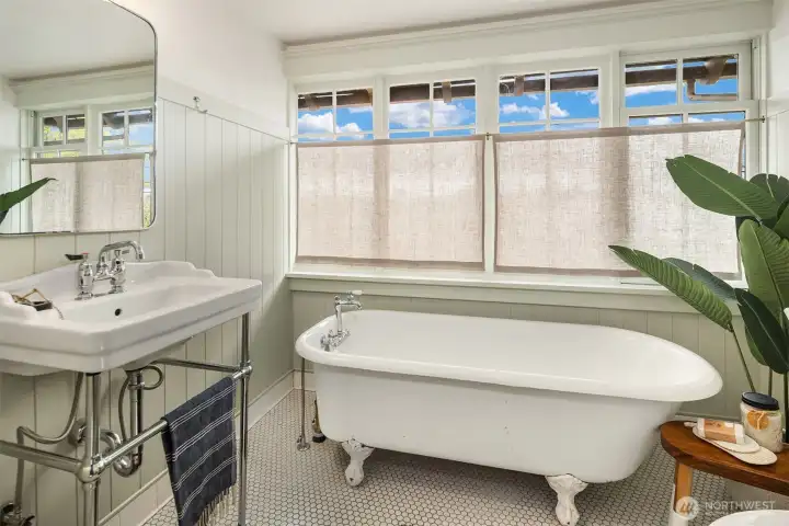 This is the Primary Bath with refinished vintage soaking tub.