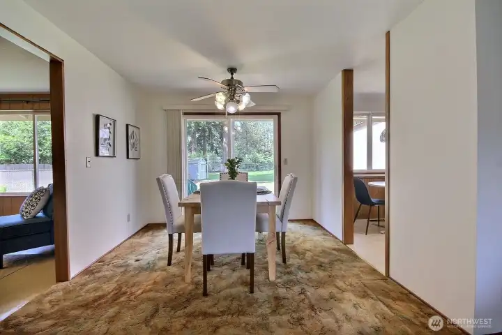 The dining room creates a seamless connection between cooking, dining, and the backyard patio.