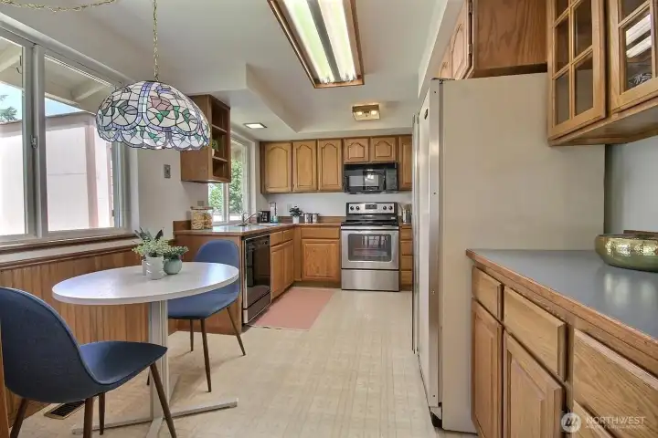 Kitchen just off the dining room features a dinette space and overlooks the back yard.