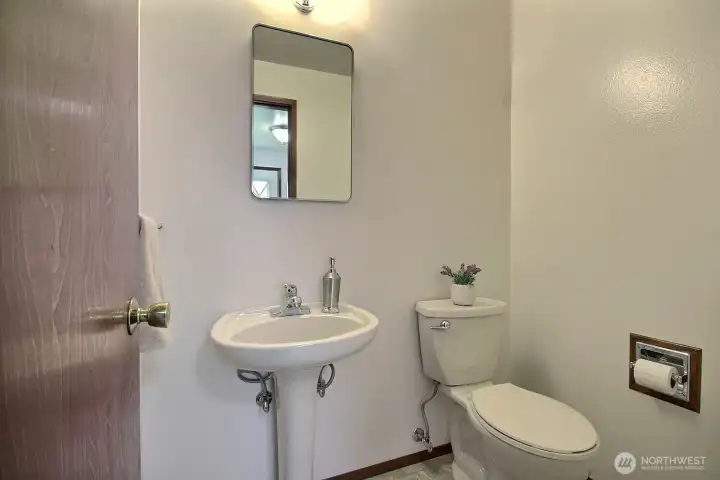 Conveniently located guest bath provides quick access from the garage and entertaining spaces.