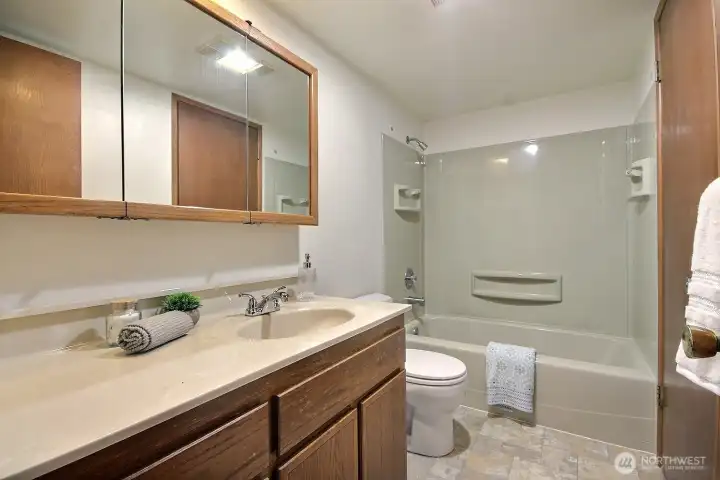 The full bath layout offers both hall access for guests and private access from the primary bedroom.