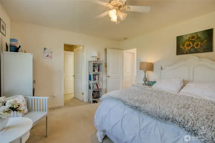 Walk-in closet steps into the primary bath.
