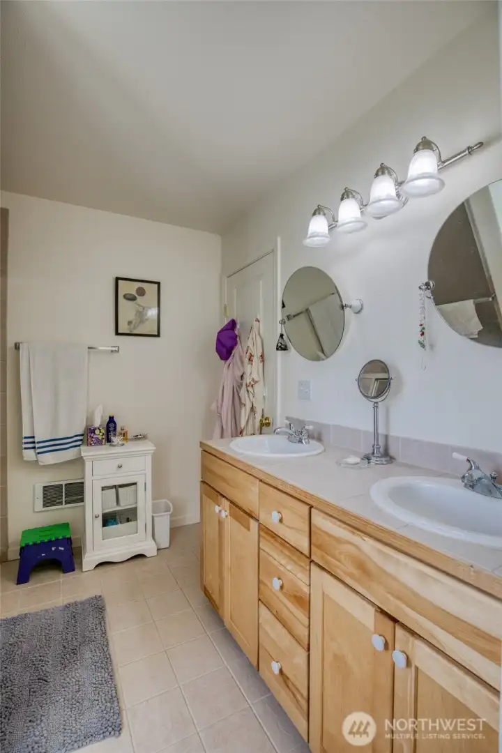 Main level bath has double sinks.