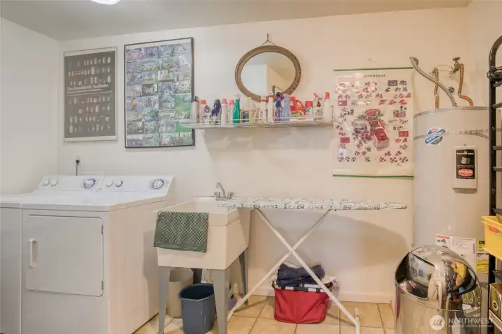 A utility sink is included and there's lots of room for storage on the shelving to the right.