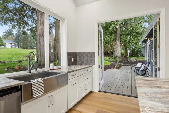 The kitchen opens to an upgraded Trex deck overlooking the fairway, practically begging for summer BBQs. The kitchen opens to an upgraded Trex deck overlooking the fairway, practically begging for summer BBQs.