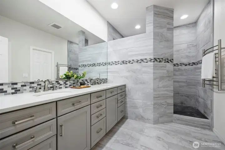 A spa-worthy primary bath featuring dual vanities and custom tilework you'll want to show off. A spa-worthy primary bath featuring dual vanities and custom tilework you'll want to show off.
